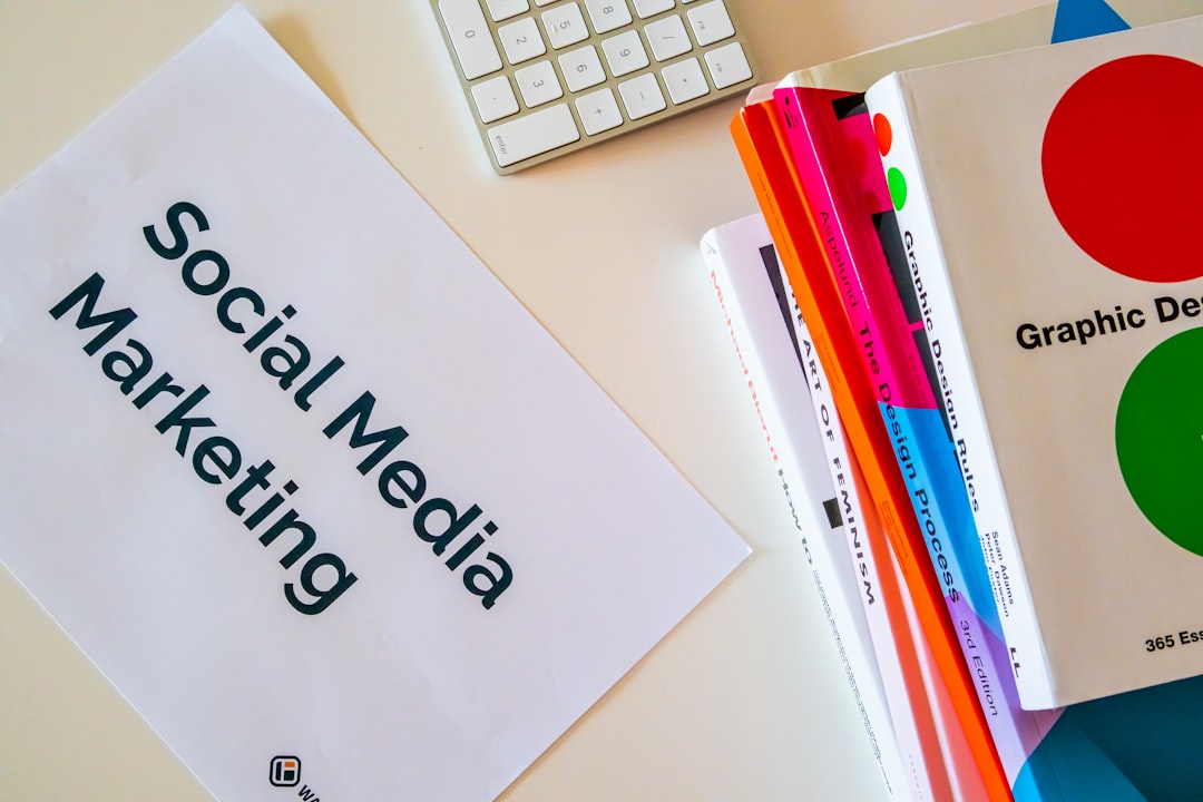 heros-img Home desk with design books and a paper with the words Social Media Marketing on it